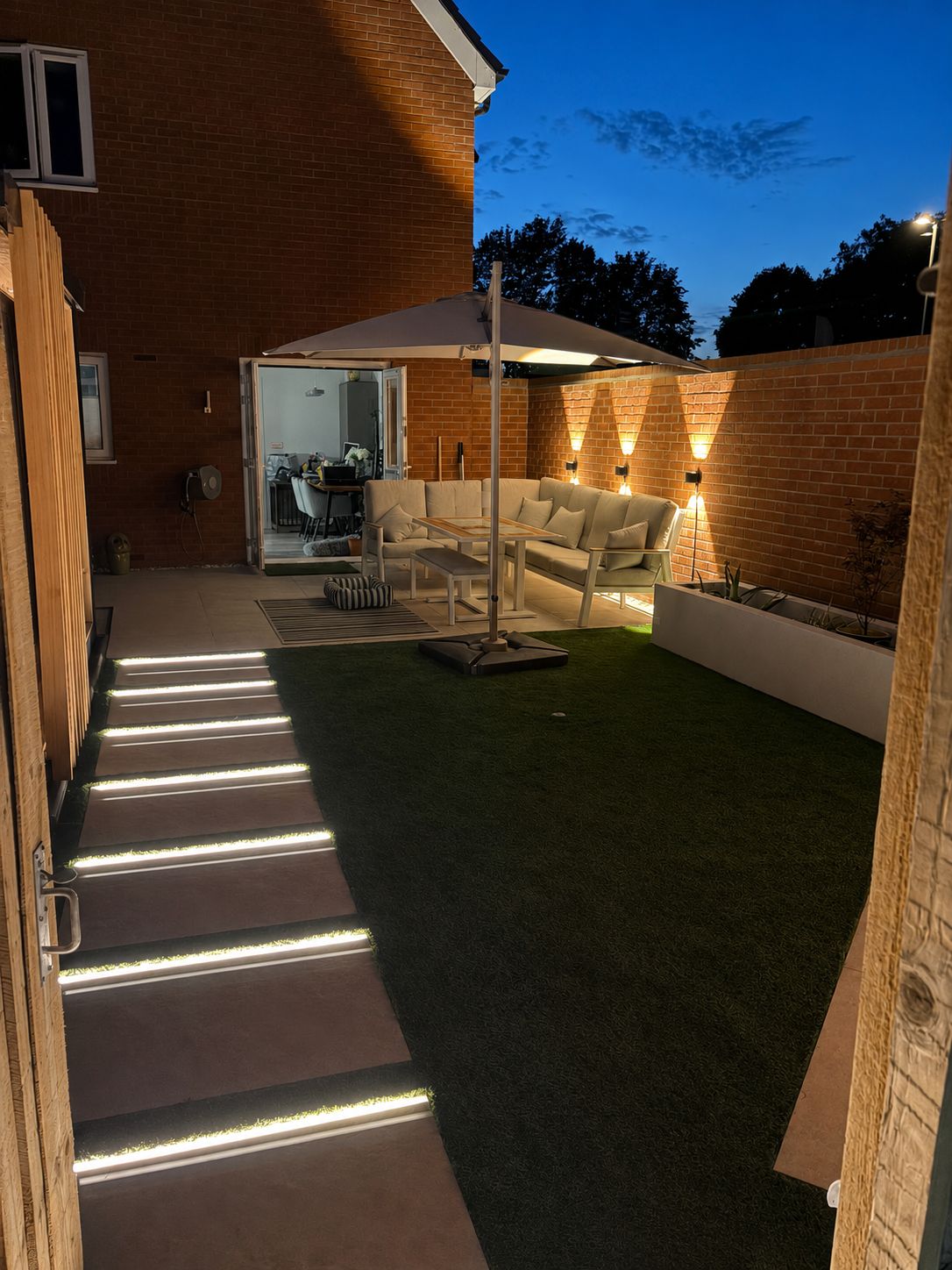 Finished garden lit at dusk in Northamptonshire